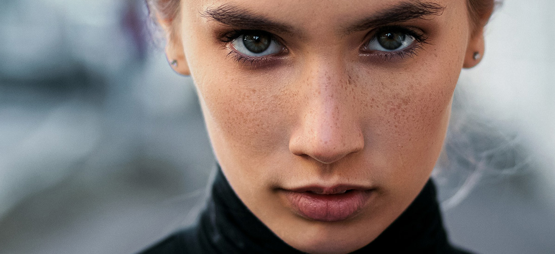 Caucasian Female Face with Grey Eyes and Freckles