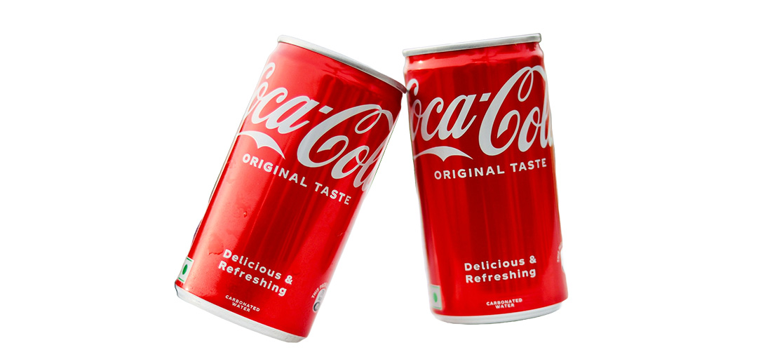Two edited red cans of Coca Cola softdrink with White Background
