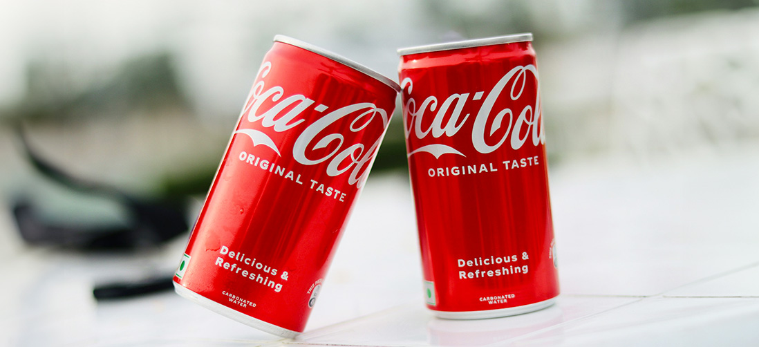 Two red cans of Coca Cola softdrink unedited